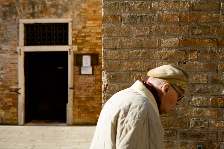Venice, Italy - old man passing by, color photo