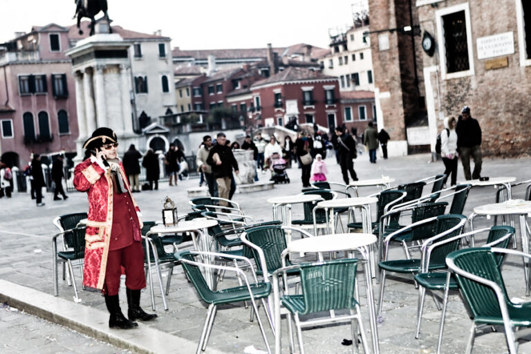 Venice-gentleman dressed in 18th century costume on the cellphone in Venice, color landscape photo