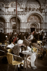 Venice-couple in carnival costume kissing in St. Mark's square, color portrait photo