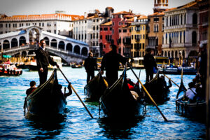 Venice, Italy - gondolas in Grand Canal nearby Rialto Bridge, color photo