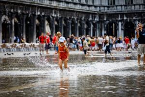 Venice - kids playing with high-water in St. Mark's Square, color landscape photo