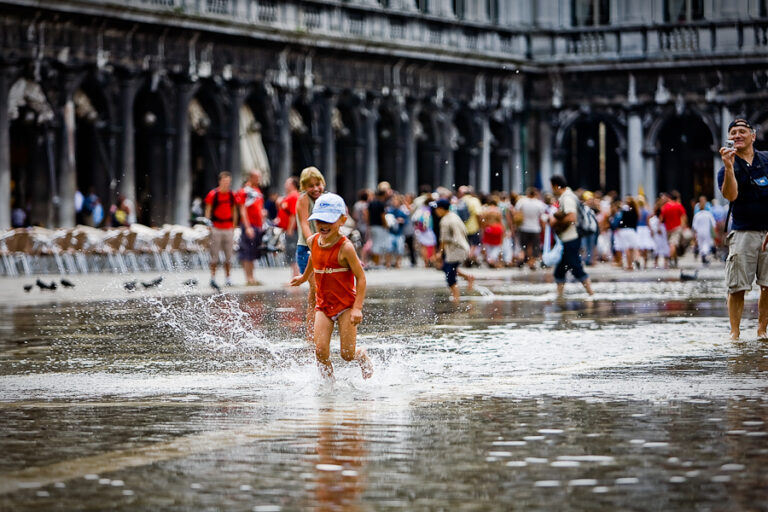 Venice - kids playing with high-water in St. Mark's Square, color landscape photo