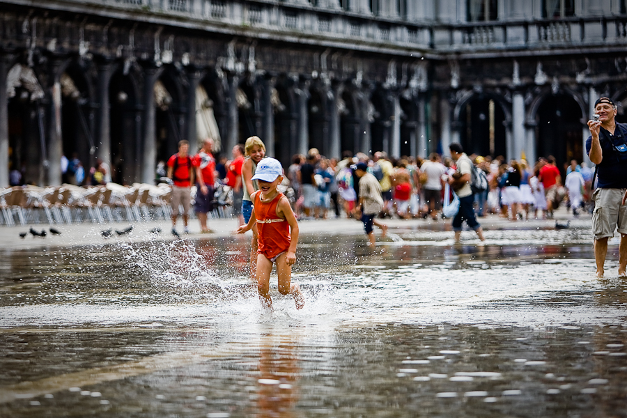 Venice - kids playing with high-water in St. Mark's Square, color landscape photo