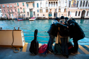 Venice-three boys on a waterbus in Grand Canal