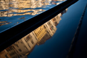 Venice - reflections of Grand Canal palaces over the side of a gondola , color landscape photo