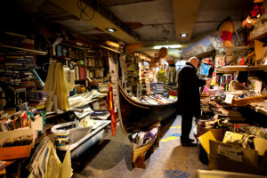 Venice - gondola used as bookshelf inside a bookstore, color landscape photo