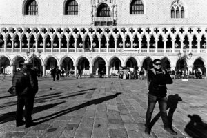 Venice - gondolier and tourist in front of Doge's Palace