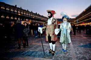 Venice - couple in carnival costume in St. Mark's square, color landscape photo