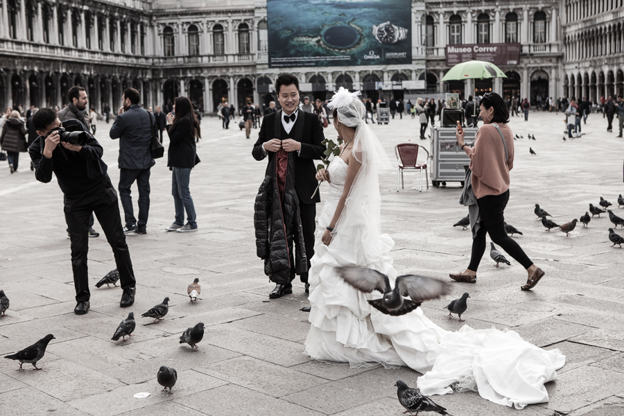 Venice - newlyweds from Asia take a walk in St. Mark's square, color landscape photo
