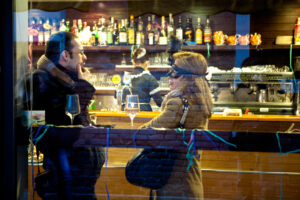 Venice-couple chatting at the cafè during Carnival, color landscape photo